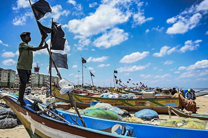 A fisherman hoists a black flag in Chennai as a sign of protest against the Indian Marine Fisheries Bill 2021.