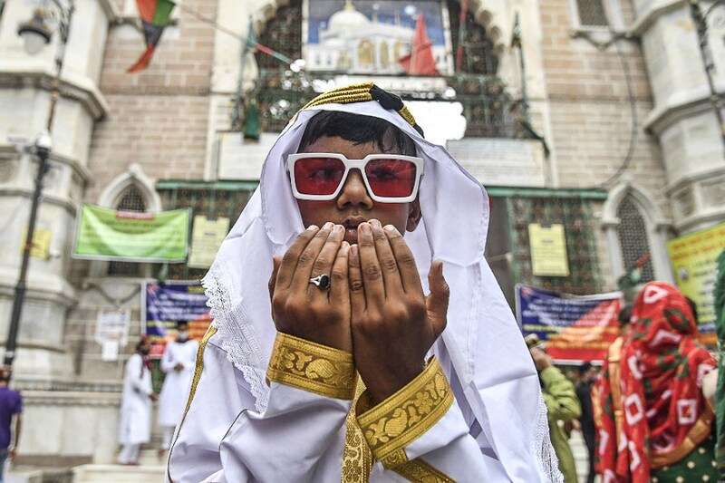 A young Muslim devotee offers prayers during the Eid al-Adha or the "Festival of Sacrifice, in Ajmer, India, on July 21, 2021. Businesses around the festival have been strongly hampered due to uncertainties and the fear of a third wave of the deadly virus.