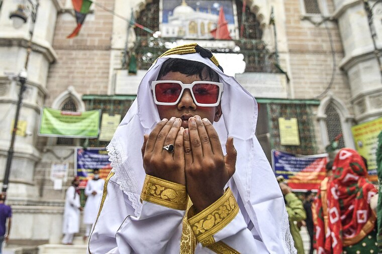 A young Muslim devotee offers prayers during the Eid al-Adha or the "Festival of Sacrifice, in Ajmer, India, on July 21, 2021. Businesses around the festival have been strongly hampered due to uncertainties and the fear of a third wave of the deadly virus.