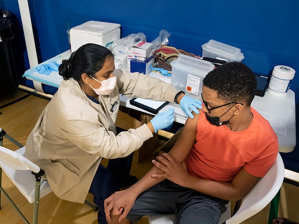A student receives a second dose of the Pfizer coronavirus vaccine at the Morris Heights Heath Center in the Bronx on Tuesday, July 27, 2021. The Pfizer-BioNTech vaccine’s effectiveness wanes slightly over time, according to newly released data from the companies, but remains strong in preventing severe disease. Image: James Estrin/The New York Times