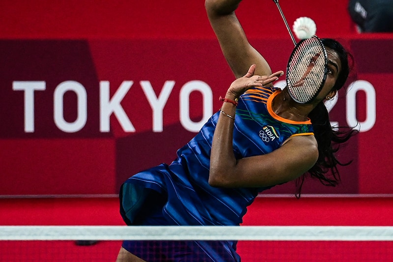 India"s P. V. Sindhu hits a shot to Denmark"s Mia Blichfeldt in their women"s singles badminton round of 16 match during the Tokyo 2020 Olympic Games at the Musashino Forest Sports Plaza in Tokyo on July 29, 2021. Sindhu won the game 21-15, 21-13 to enter the quarterfinals.