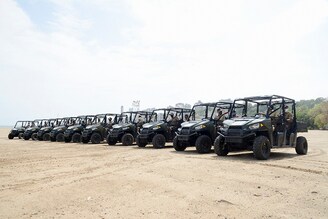 Police personnel sit on their all-terrain vehicle (ATV) used to patrol beaches at Girgaon Chowpatty beach in Mumbai on June 7, 2021.