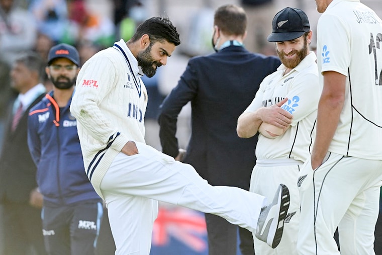 India"s Virat Kohli (L) and New Zealand"s captain Kane Williamson react before the presentation on the final day of the ICC World Test Championship Final between New Zealand and India at the Ageas Bowl in Southampton, Southwest England. New Zealand beat India by 8 wickets.