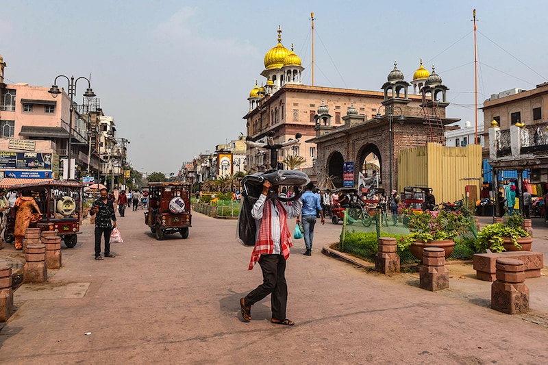 A man walks on the main Chandni Chowk road carrying an office chair on his head in New Delhi, India. One of the busiest areas in the national capital, Chandni Chowk, was recently declared a non-motorised zone. No motor vehicle would be allowed to ply on the main Chandni Chowk Road from Red Fort to Fatehpuri Mosque from 9am to 9pm on all days.