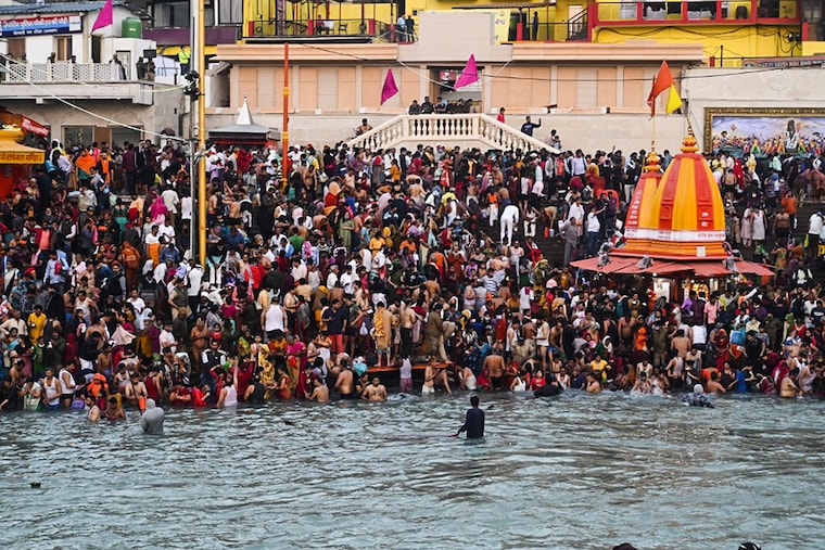 Hindu devotees take a holy dip in the waters of the River Ganges on the Shahi Snan (grand bath) on the occasion of Maha Shivratri festival during the ongoing religious Kumbh Mela festival in Haridwar on March 11, 2021.