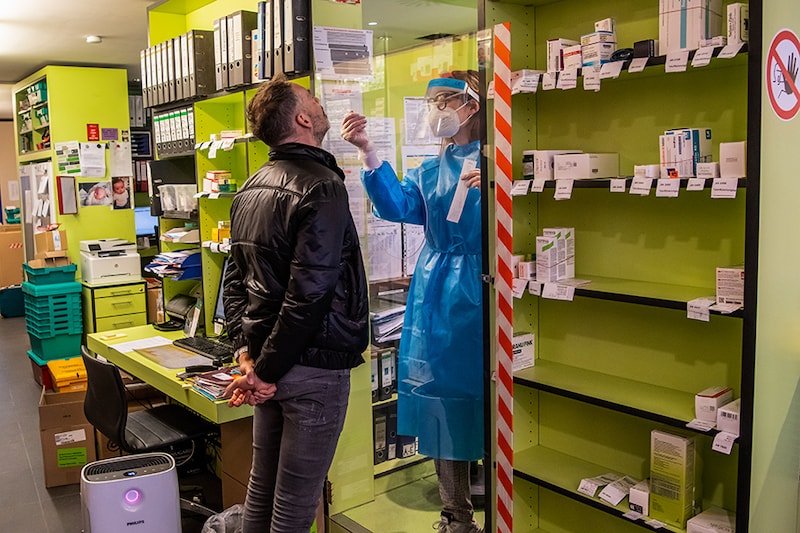 Customer Johann Maurer gets a nasal swab taken by pharmacist Josefine Wiecha for a free Corona quick test at a pharmacy in the city centre. Bavaria"s pharmacies can now offer free Corona quick tests for citizens without cold symptoms.