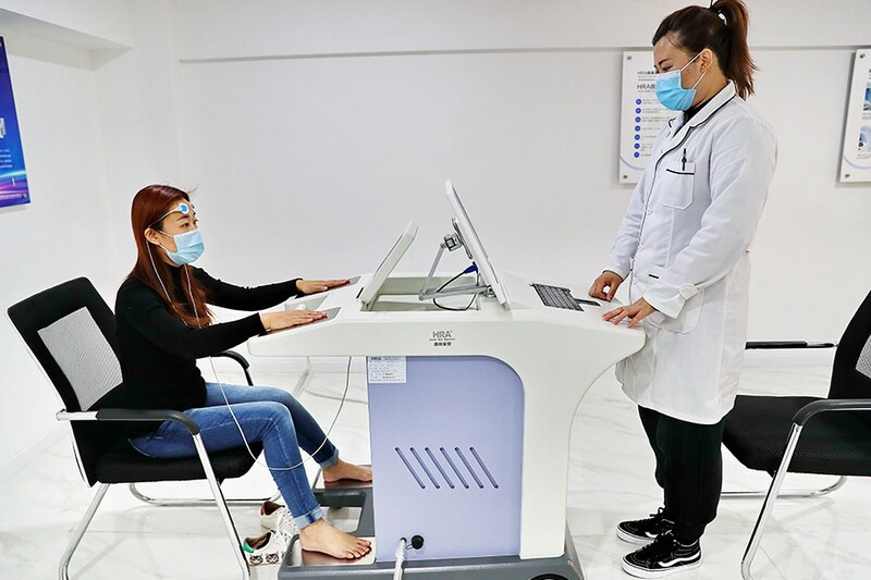 A citizen experiences Health Risk Appraisal (HRA) system at an AI sleep management centre before World Sleep Day on March 17, 2021 in Qinhuangdao, Hebei Province of China.