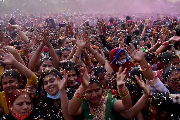 Devotees are showered with flower petals during "Phoolon Ki Holi" celebrations, as part of Holi celebrations, amidst the spread of the coronavirus disease (COVID-19), in Mathura, in the northern state of Uttar Pradesh, India, March 25, 2021.