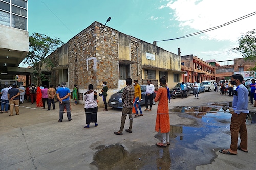 People stand in a queue as they wait for Covid-19 tests, at CMHO in Jaipur, Rajasthan, India on Monday, May 10, 2021.