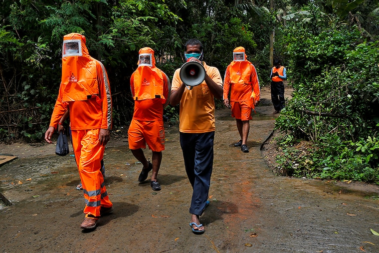 A member of the National Disaster Response Force (NDRF) uses a megaphone to appeal to residents to move to a safer place ahead of Cyclone Yaas at Digha in Purba Medinipur district in the eastern state of West Bengal, India, May 25, 2021.