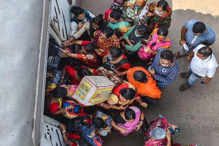Commuters trying to board n a suburban train in Kolkata after the West Bengal government restarted the railway service with 50 percent passengers amid the ongoing COVID-19 pandemic.