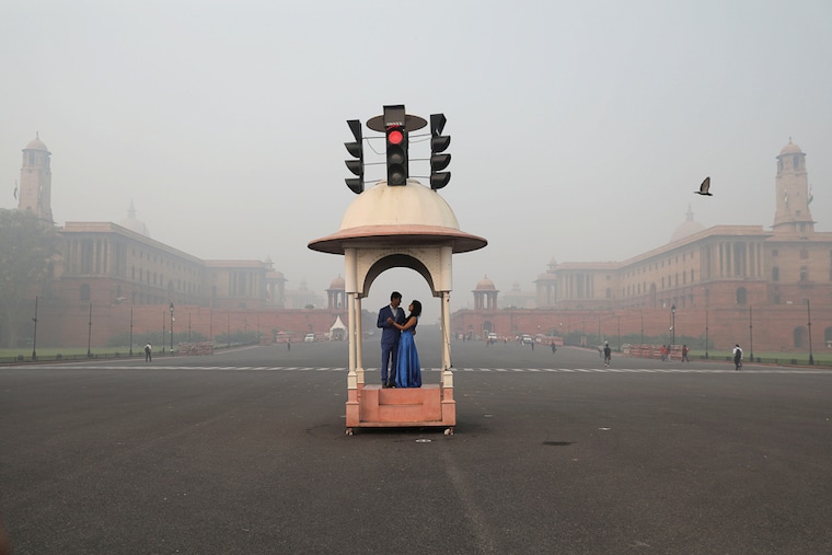 A couple poses during a pre-wedding photo shoot near Raisina Hill which is shrouded in smog in New Delhi, India. The smog, precipitated by burst crackers during Diwali celebrations on November 5, persists over the city two days after the festival.