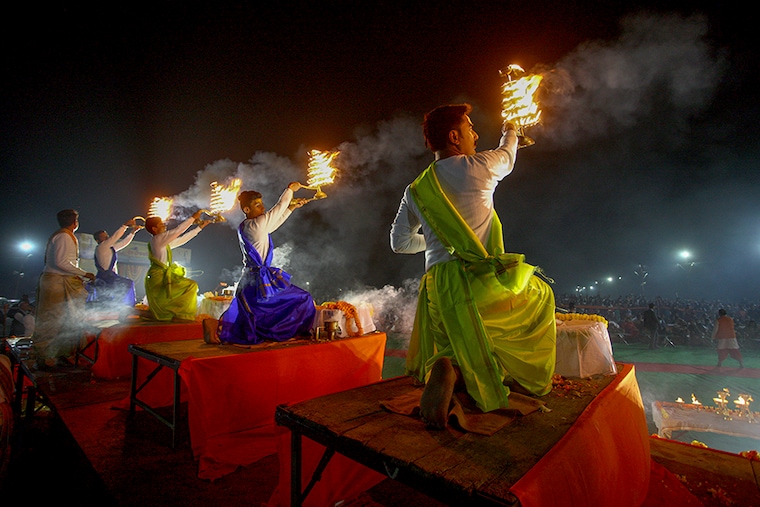 Priests hold traditional incense lamps as they perform aarti to offer prayers on the banks of Sangam, the confluence of the Ganges, Yamuna and Saraswati rivers, during Dev Deepawali festival in Prayagraj, India, November 19, 2021.