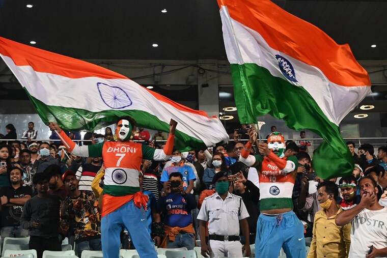 Cricket fans wave Indian national flag after India"s victory in the third Twenty20 International cricket match between India and New Zealand at the Eden Gardens in Kolkata on November 21, 2021.