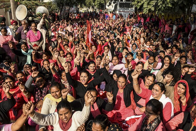 Asha workers and Facilitators Union members shout slogans during a protest against the state government demanding better working conditions, outside the residence of Punjab Deputy Chief Minister O.P. Soni, in Amritsar on November 22, 2021.