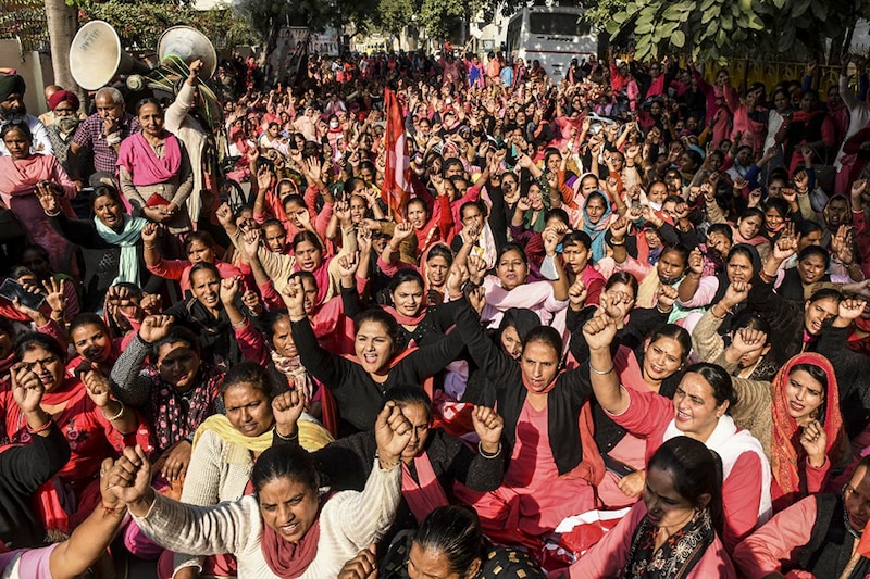Asha workers and Facilitators Union members shout slogans during a protest against the state government demanding better working conditions, outside the residence of Punjab Deputy Chief Minister O.P. Soni, in Amritsar on November 22, 2021.