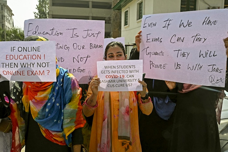 University students hold placards during a protest, demanding the local administration conduct online examinations amid Covid-19 coronavirus pandemic in Srinagar on October 4, 2021.
