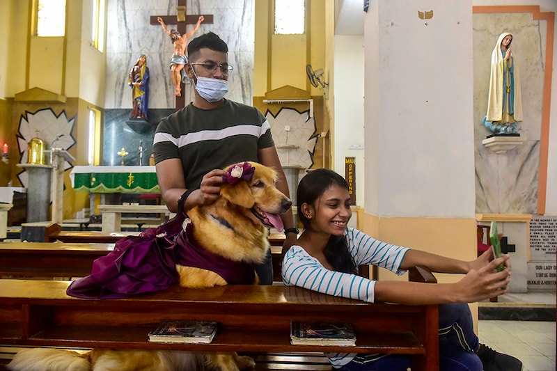 On the occasion of pet blessing day, an animal lover takes a selfie with her dog during a blessing ceremony in Mumbai"s St. John the Evangelist Church, on October 10, 2021.