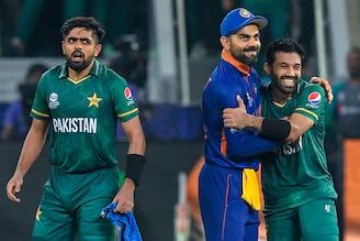 India’s captain Virat Kohli (C) congratulates his Pakistan counterpart Babar Azam (L) and Mohammad Rizwan following their victory during the ICC Men"s Twenty20 World Cup cricket match between India and Pakistan at the Dubai International Cricket Stadium in Dubai on October 24, 2021.