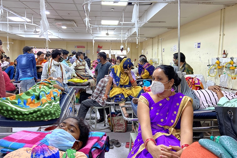 People are seen on stretchers at an emergency ward of a government hospital as dengue cases in the city cross the 1000-mark, in New Delhi, India, October 26, 2021.