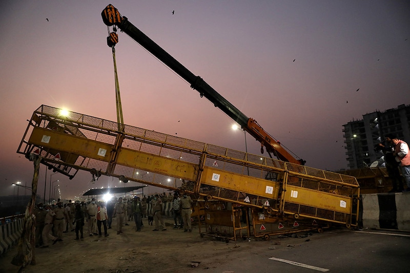 Police remove a barricade at the site of the farmers" protest against farm laws at Ghazipur, near the Delhi-Uttar Pradesh border, in New Delhi, India, October 29, 2021.