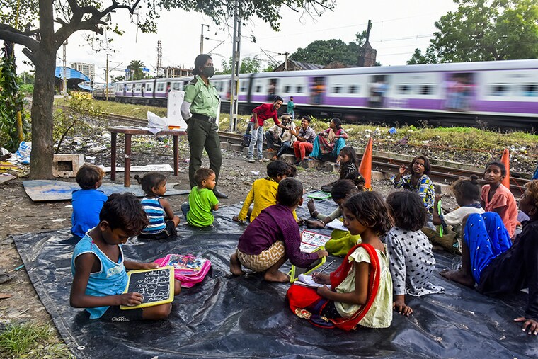 A Kolkata police woman takes private class for slum children in Kolkata, India, on 8th September, 2021.