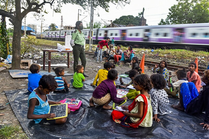 A Kolkata police woman takes private class for slum children in Kolkata, India, on 8th September, 2021.