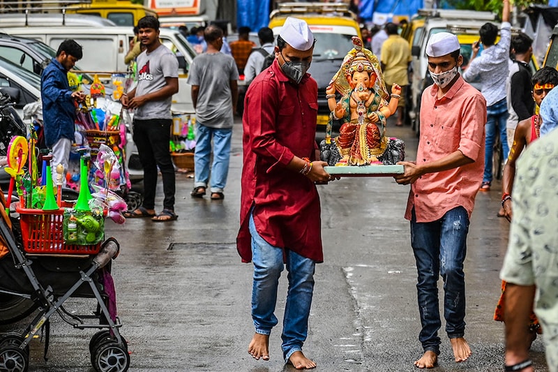 Devotees carry an idol of the god Ganesha on the first day of the ten-day-long Ganesh Chaturthi festival in Mumbai on September 10, 2021.