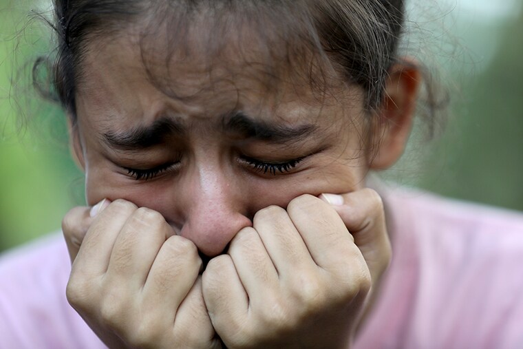An Afghan girl cries during a peaceful protest ahead of the International Day of Peace at a park in New Delhi, India.