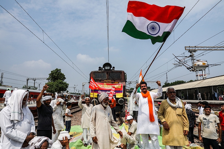 Farmers block railway tracks as part of nationwide protests against farm laws in Sonipat, Haryana, on September 27, 2021.