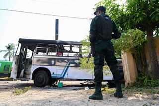 A soldier guards an area next to a burnt-out bus near the Sri Lankan president"s home in Colombo on April 1, 2022. - Security forces were deployed across the Sri Lankan capital on April 1 after protesters tried to storm the president"s home in anger at the nation"s worst economic crisis since independence. (Credit: Ishara S. KODIKARA / AFP)