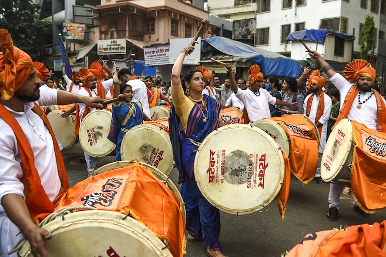 Women and men dressed in traditional attire play drums as they take part in a procession celebrating "Gudi Padwa" or the Maharashtrian New Year, in Mumbai on April 2, 2022.