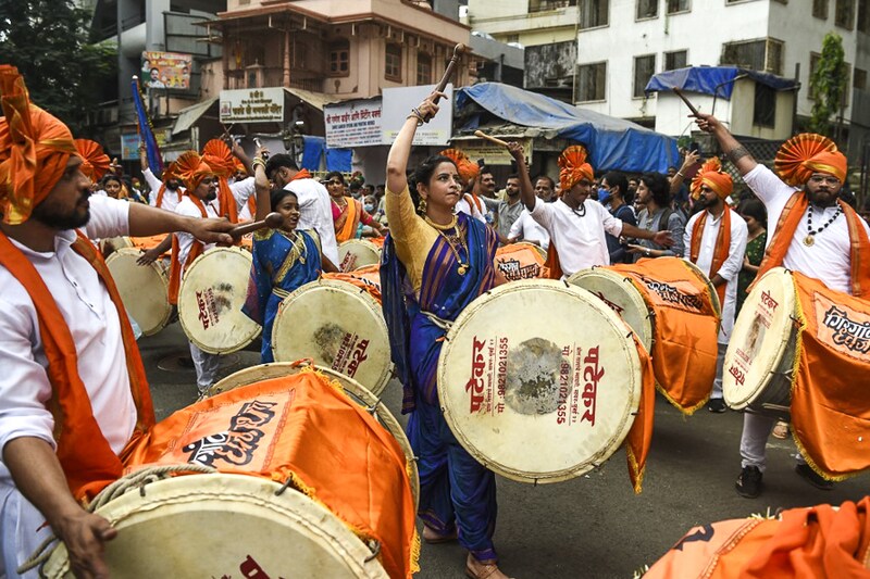 Women and men dressed in traditional attire play drums as they take part in a procession celebrating "Gudi Padwa" or the Maharashtrian New Year, in Mumbai on April 2, 2022.
