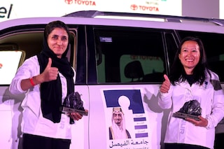 A picture taken on March 19, 2022 shows UAE"s driver Atefa Saleh (L) and her co-driver US Eleana Coker celebrating after they won the second place in Rally Jameel, Saudi ArabiaÃs first ever women only motor rally, in Riyadh on March 19, 2022. (Photo by Fayez Nureldine / AFP)
