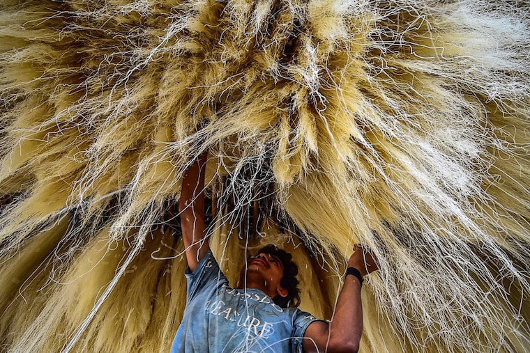 A worker stacks vermicelli, which is used in making traditional desserts widely consumed during the holy month of Ramadan, at a factory in Prayagraj on April 5, 2022.