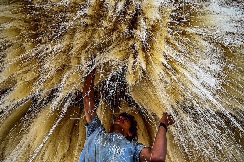 A worker stacks vermicelli, which is used in making traditional desserts widely consumed during the holy month of Ramadan, at a factory in Prayagraj on April 5, 2022.