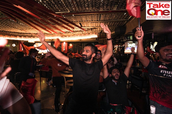 RCB fans cheer for the team at the RCB Bar &amp Cafe in Bengaluru. The sports cafe, launched in December 2020, was the IPL franchise"s first foray into lifestyle