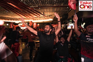 RCB fans cheer for the team at the RCB Bar & Cafe in Bengaluru. The sports cafe, launched in December 2020, was the IPL franchise"s first foray into lifestyle