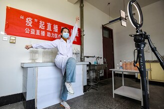 On the occasion of World Health Day, a staff member of the Centre for Disease Control and Prevention demonstrates home aerobics on a live streaming platform in Handan, Hebei Province, China, on April 7, 2022.