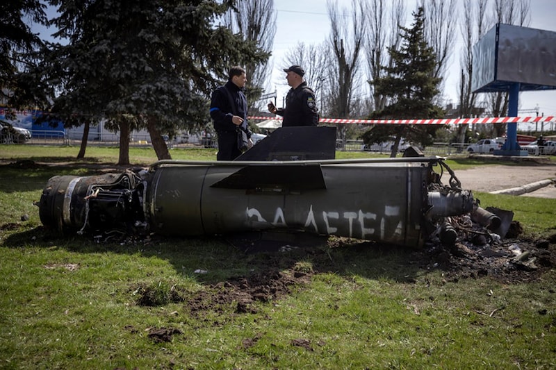 Ukrainian police inspect the remains of a large rocket with the words "for our children" inscribed in Russian next to the main building of a train station that was being used for civilian evacuations in Kramatorsk, eastern Ukraine on April 8, 2022. The station was hit by a rocket attack, killing at least 35 people.