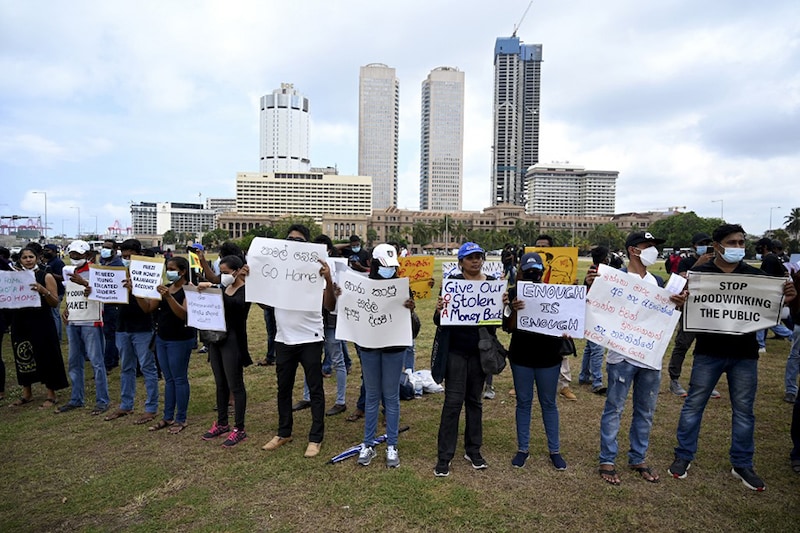 Protesters hold placards as they take part in a demonstration in Colombo on April 9, 2022. Security forces were reinforced in Sri Lanka"s capital on April 9, officials said, as church and business leaders joined growing protests demanding the president"s resignation over the worsensing economic crisis.