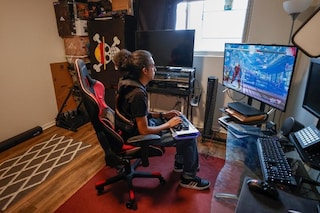 Chris Robinson plays a video game in his apartment on March 26, 2022, in Justice, Illinois.
Image: Kamil Krzaczynski / AFP