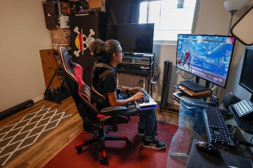 Chris Robinson plays a video game in his apartment on March 26, 2022, in Justice, Illinois.
Image: Kamil Krzaczynski / AFP Chris Robinson plays a video game in his apartment on March 26, 2022, in Justice, Illinois.
Image: Kamil Krzaczynski / AFP
