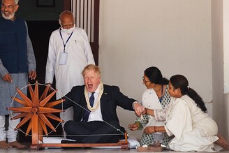 British Prime Minister Boris Johnson is shown how to operate a cotton wheel during his visit to the Sabarmati Ashram also known as Gandhi Ashram on April 21, 2022, in Ahmedabad, India. During his two-day visit to India, Boris Johnson is expecting to seal new collaborations on defence and green energy as he seeks to reduce the country"s dependence on Russian fossil fuels and military equipment.