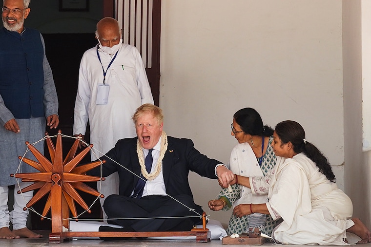 British Prime Minister Boris Johnson is shown how to operate a cotton wheel during his visit to the Sabarmati Ashram also known as Gandhi Ashram on April 21, 2022, in Ahmedabad, India. During his two-day visit to India, Boris Johnson is expecting to seal new collaborations on defence and green energy as he seeks to reduce the country"s dependence on Russian fossil fuels and military equipment.