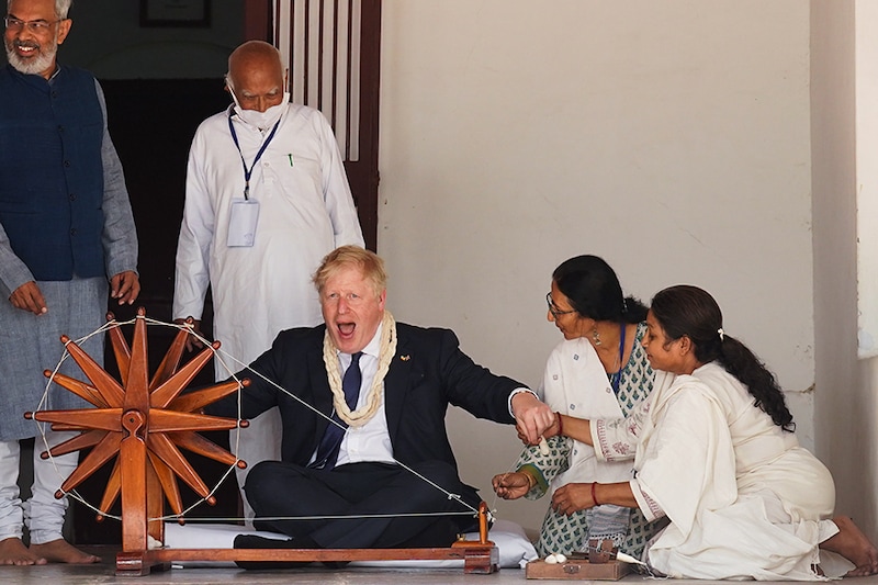 British Prime Minister Boris Johnson is shown how to operate a cotton wheel during his visit to the Sabarmati Ashram also known as Gandhi Ashram on April 21, 2022, in Ahmedabad, India. During his two-day visit to India, Boris Johnson is expecting to seal new collaborations on defence and green energy as he seeks to reduce the country"s dependence on Russian fossil fuels and military equipment.
