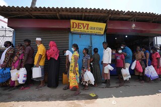 Sri Lankans queue up to purchase kerosene oil near a fuel station in Colombo, Sri Lanka, Thursday, April 7, 2022. Sri Lanka is facing its worst economic crisis in memory with an acute foreign currency crisis leading to sever shortage of essentials like medicines, foods, fuel, cooking gas and power cuts lasting hours. Image: AP Photo/Eranga Jayawardena