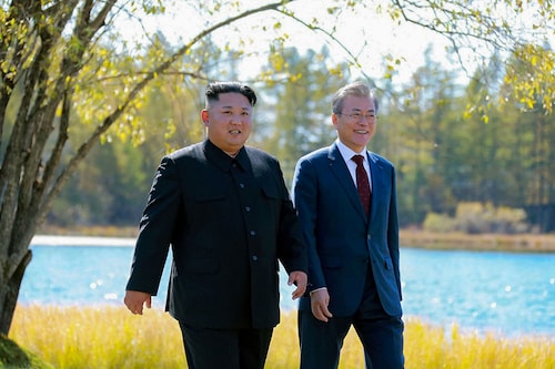 This picture taken on September 20, 2018 and released by Korean Central News Agency (KCNA) via KNS shows North Korea"s leader Kim Jong Un (L) and South Korean President Moon Jae-in (R) walking together during a visit to Samjiyon guesthouse near Mount Paektu in Samjiyon. (Photo by KCNA VIA KNS / various sources / AFP)