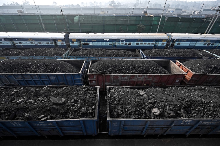 Goods trains loaded with coal at a railway station in Singrauli in India"s Madhya Pradesh. Passenger trains are being cancelled to rush coal rakes to power plants across the country as low supplies have set off blackouts. Demand for electricity has spiked due to an unusually early, record shattering heatwave. April 30, 2022.