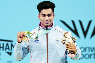 Gold Medallist for the Men"s 73kg Weightlifting, India"s Achinta Sheuli celebrates on the podium during the medal ceremony at The NEC Hall 1, Birmingham, Britain - July 31, 2022.